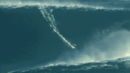 Un surfeur se lève sur une vague gigantesque